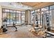 Well-equipped gym with floor to ceiling windows, weights, and exercise machines at 20 Wilcox St # 203, Castle Rock, CO 80104