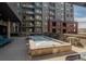 Inviting rooftop with a hot tub, fire pit, and outdoor seating area at 20 Wilcox St # 203, Castle Rock, CO 80104