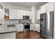 Sleek kitchen with stainless steel appliances, subway tile backsplash, and ample cabinet space at 20 Wilcox St # 203, Castle Rock, CO 80104