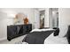 Bedroom featuring a dark wood dresser and views to the kitchen and bathroom area at 20 Wilcox St # 203, Castle Rock, CO 80104