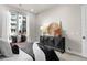 Bright bedroom with sleek modern decor and natural light, overlooking a brick-facade building at 20 Wilcox St # 203, Castle Rock, CO 80104