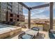 Relaxing rooftop patio with a hot tub, fire pit, and panoramic views of the cityscape at 20 Wilcox St # 203, Castle Rock, CO 80104