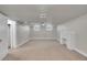 A spacious basement with neutral carpet, a decorative fireplace, and two windows for natural light at 1208 S Elizabeth St, Denver, CO 80210