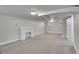 Neutral carpet in this finished basement with windows and a non-functional brick fireplace at 1208 S Elizabeth St, Denver, CO 80210