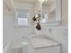 Classic bathroom featuring white tiles, marble countertop, and updated fixtures at 1208 S Elizabeth St, Denver, CO 80210