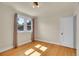 Bright bedroom featuring hardwood floors, a large window, and classic door at 1208 S Elizabeth St, Denver, CO 80210