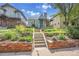 Charming home with landscaped front yard, stone retaining wall, and a welcoming front porch at 1208 S Elizabeth St, Denver, CO 80210