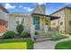 Inviting bungalow with awning, landscaping, and well-maintained lawn at 1208 S Elizabeth St, Denver, CO 80210