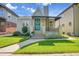 Inviting bungalow with awning, landscaping, and well-maintained lawn at 1208 S Elizabeth St, Denver, CO 80210