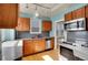 Updated kitchen features wood cabinets, stainless steel appliances, and a large window at 1208 S Elizabeth St, Denver, CO 80210
