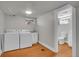 Basement laundry room with vinyl floors and washer/dryer hookups with access to bathroom at 1208 S Elizabeth St, Denver, CO 80210