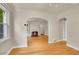 Charming living room with hardwood floors and fireplace with archways to other rooms at 1208 S Elizabeth St, Denver, CO 80210