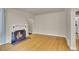 Bright living room featuring a fireplace, hardwood floors, and an arched doorway at 1208 S Elizabeth St, Denver, CO 80210