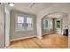 Sun-filled living room featuring hardwood floors and a charming archway at 1208 S Elizabeth St, Denver, CO 80210