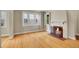 Inviting living room with a cozy fireplace and gleaming hardwood floors at 1208 S Elizabeth St, Denver, CO 80210