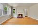 Cozy living room featuring a warm fireplace and ample natural light at 1208 S Elizabeth St, Denver, CO 80210