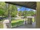 Scenic view from porch, showcasing a well-manicured lawn and lush trees at 1208 S Elizabeth St, Denver, CO 80210