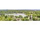 Aerial view showcasing a lush park surrounding a serene lake, near a neighborhood and urban cityscape at 328 E Dakota Ave, Denver, CO 80209