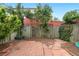 Private backyard with lush landscaping, a patio, and a charming green fence at 328 E Dakota Ave, Denver, CO 80209