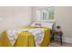 Cozy bedroom featuring bright natural light and simple decor with a wooden nightstand at 328 E Dakota Ave, Denver, CO 80209