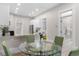 Bright dining area with modern table, chairs and updated kitchen with stainless appliances at 328 E Dakota Ave, Denver, CO 80209