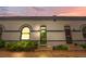 Charming home exterior showcasing a well-maintained yard, arched windows, and a secure front door at 328 E Dakota Ave, Denver, CO 80209