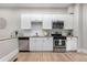 Contemporary kitchen featuring stainless steel appliances, white cabinets, and granite countertops at 328 E Dakota Ave, Denver, CO 80209
