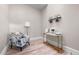 Well lit room with hardwood floors, a decorative chair, side table and modern decor at 328 E Dakota Ave, Denver, CO 80209