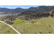 Expansive aerial view showcasing the property's vast land and proximity to town at 15947 S Perry Park Rd, Palmer Lake, CO 80133