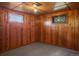 Finished basement featuring classic wood paneling and natural light, creating a versatile and inviting space at 15947 S Perry Park Rd, Palmer Lake, CO 80133