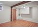 Bright basement with wood floors, overhead cabinets, and rustic beam, providing a functional and inviting space at 15947 S Perry Park Rd, Palmer Lake, CO 80133