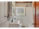 Charming bathroom with subway tile, decorative ceiling, and a window offering a view of blossoming trees at 15947 S Perry Park Rd, Palmer Lake, CO 80133