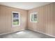 Cozy bedroom with soft carpet and natural light streaming through two windows, creating a serene atmosphere at 15947 S Perry Park Rd, Palmer Lake, CO 80133