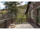 Outdoor deck on a log home with rustic charm and picturesque views of the surrounding lush greenery at 15947 S Perry Park Rd, Palmer Lake, CO 80133