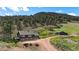 Charming home with a forest backdrop, barn, and large parcel at 15947 S Perry Park Rd, Palmer Lake, CO 80133