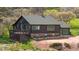 Charming log cabin with deck and stone foundation, nestled in a serene setting at 15947 S Perry Park Rd, Palmer Lake, CO 80133