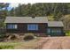 Inviting log cabin with green trim, garage, and easy access to the driveway at 15947 S Perry Park Rd, Palmer Lake, CO 80133