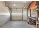 Spacious garage with white paneled door and workshop area provides functionality and scenic views at 15947 S Perry Park Rd, Palmer Lake, CO 80133