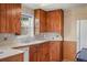 Vintage kitchen with tile countertops and rustic wood cabinetry, capturing a cozy, country charm at 15947 S Perry Park Rd, Palmer Lake, CO 80133