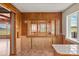 Kitchen area featuring vintage wood cabinets, tile countertops, and window with scenic view at 15947 S Perry Park Rd, Palmer Lake, CO 80133