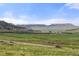 Expansive view of rolling hills and mountains in a green rural landscape at 15947 S Perry Park Rd, Palmer Lake, CO 80133