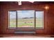 Breathtaking panoramic view from a large window showcasing rolling hills and distant mountains, inviting natural beauty indoors at 15947 S Perry Park Rd, Palmer Lake, CO 80133