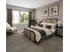 A cozy bedroom with a decorative headboard, two windows, and neutral color tones at 17085 W 92Nd Loop, Arvada, CO 80007