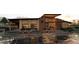 Community clubhouse exterior featuring modern design, seating area, and well-maintained landscaping at 17085 W 92Nd Loop, Arvada, CO 80007