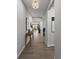 Hallway featuring wood floors, neutral paint, contemporary artwork, and natural light at 17085 W 92Nd Loop, Arvada, CO 80007