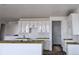 A bright kitchen featuring white cabinets, a large island, and subway tile backsplash awaiting final finishes at 17085 W 92Nd Loop, Arvada, CO 80007