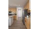 Well-equipped kitchen with wood cabinets, stainless steel appliances, and a practical layout at 17085 W 92Nd Loop, Arvada, CO 80007