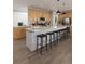 Large kitchen island with bar stool seating, modern light fixtures, and stainless steel appliances at 17085 W 92Nd Loop, Arvada, CO 80007