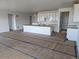 Spacious open-concept kitchen with white cabinets, a large island, and recessed lighting at 17085 W 92Nd Loop, Arvada, CO 80007