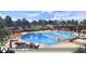 Community pool area featuring sun loungers, umbrellas, and a relaxing atmosphere at 17085 W 92Nd Loop, Arvada, CO 80007
